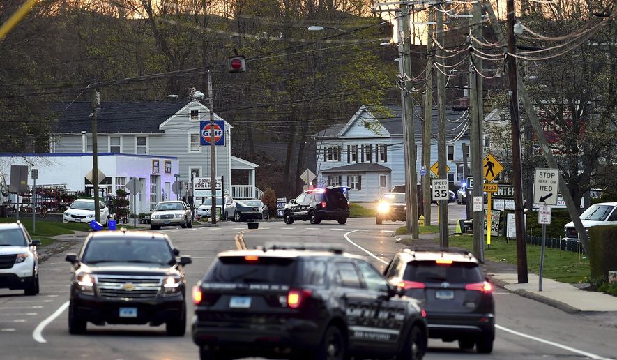 Branford Police respond at the scene of a shooting on Main Street, Tuesday, April 13, 2021, in Branford, Conn. A man who fired numerous gunshots from a building as police surrounded the property was found dead inside, police said. Police said the man holed up in a building on Main Street in Branford, a New Haven suburb. One person was reported injured. (Arnold Gold/Hearst Connecticut Media/New Haven Register via AP)