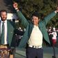 Hideki Matsuyama, of Japan, celebrates while wearing the champion&#39;s green jacket as Dustin Johnson looks on after winning the Masters golf tournament on Sunday, April 11, 2021, in Augusta, Ga. (Curtis Compton/Atlanta Journal-Constitution via AP)
