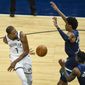 Brooklyn Nets forward Kevin Durant (7) passes the ball behind his back and around Minnesota Timberwolves forward Jaden McDaniels (3) and Timberwolves forward Jarred Vanderbilt (8) during the first half of an NBA basketball game Tuesday, April 13, 2021, in Minneapolis. (AP Photo/Craig Lassig)