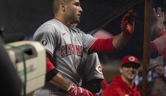 Cincinnati Reds first baseman Joey Votto (19) is greeted by his teammates after hitting a solo home run against the San Francisco Giants during the sixth inning of a baseball game, Monday, April 12, 2021, in San Francisco, Calif. (AP Photo/D. Ross Cameron)
