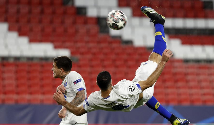 Porto&#39;s Mehdi Taremi scores his side&#39;s opening goal during the Champions League quarter final second leg soccer match between Chelsea and Porto at the Ramon Sanchez Pizjuan stadium, in Seville, Spain, Tuesday, April 13, 2021. (AP Photo/Angel Fernandez)