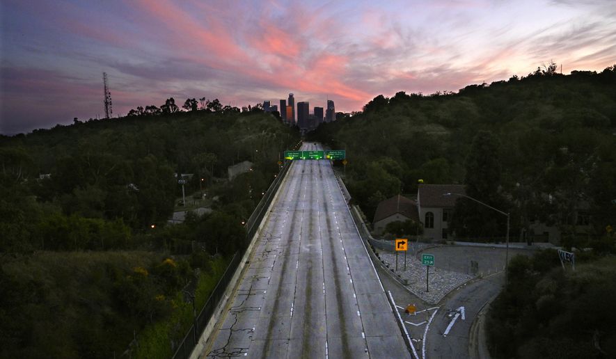 FILE - This April 26, 2020, file photo shows empty lanes of the 110 Arroyo Seco Parkway that leads to downtown Los Angeles during the coronavirus outbreak in Los Angeles, Calif. A U.S. intelligence community report says the effects of the coronavirus pandemic are expected to contribute over the next year to “humanitarian and economic crises, political unrest, and geopolitical competition." The U.S. government’s annual assessment of worldwide threats was released Tuesday, April 13, 2021. (AP Photo/Mark J. Terrill, File)