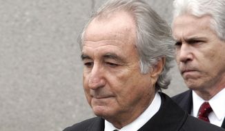 In this March 10, 2009, photo, former financier Bernie Madoff leaves federal court in Manhattan, in New York. Madoff, the financier who pleaded guilty to orchestrating the largest Ponzi scheme in history, has died in prison, a person familiar with the matter tells The Associated Press. (AP Photo/David Karp) **FILE**