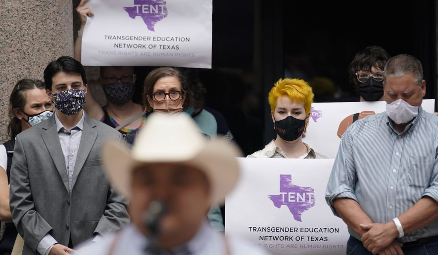 Parents of transgender children and other supporters of transgender rights gather in the capital outdoor rotunda to speak about transgender legislation being considered in the Texas House and Texas Senate, Wednesday, April 14, 2021, in Austin, Texas. (AP Photo/Eric Gay)