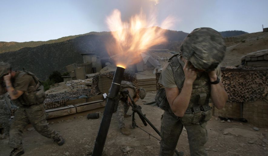 Soldiers from the U.S. Army First Battalion, 26th Infantry fire mortars from the Korengal Outpost at Taliban positions in the Korengal Valley of Afghanistan&#x27;s Kunar Province on May 12, 2009. (AP Photo/David Guttenfelder) ** FILE **