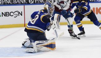 St. Louis Blues&#39; Jordan Binnington (50) blocks a shot from the Colorado Avalanche during the first period of an NHL hockey game on Wednesday, April 14, 2021, in St. Louis. (AP Photo/Joe Puetz)