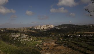 Sunlight peeks through clouds over a section of the West Bank Jewish settlement of Efrat, March 12, 2021. Israel went on an aggressive settlement spree during the Trump era, according to an AP investigation, pushing deeper into the occupied West Bank than ever before and putting the Biden administration into a bind as it seeks to revive Mideast peace efforts. (AP Photo/Maya Alleruzzo)