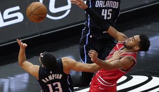 Orlando Magic guard R.J. Hampton, left, and Chicago Bulls forward Troy Brown Jr. vie for a rebound during the first half of an NBA basketball game in Chicago, Wednesday, April 14, 2021. (AP Photo/Nam Y. Huh)