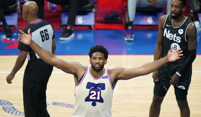 Philadelphia 76ers&#x27; Joel Embiid (21) celebrates after scoring during the second half of an NBA basketball game against the Brooklyn Nets, Wednesday, April 14, 2021, in Philadelphia. (AP Photo/Matt Slocum)