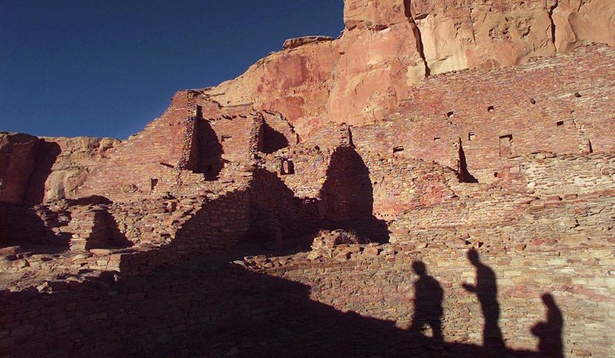 In this Nov. 21, 1996, file photo, tourists cast their shadows on the ancient Anasazi ruins of Chaco Culture National Historical Park in New Mexico. (AP Photo/Eric Draper, File)