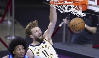 Indiana Pacers&#39; Domantas Sabonis dunks against Houston Rockets&#39; Kevin Porter Jr. during the fourth quarter of an NBA basketball game Wednesday, April 14, 2021, in Houston. (Carmen Mandato/Pool Photo via AP)