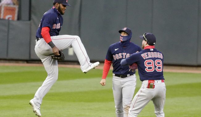 Boston Red Sox center fielder Franchy Cordero (16) jumps to celebrate with teammates right fielder Enrique Hernandez (5) and center fielder Alex Verdugo (99) after defeating the Minnesota Twins in the second baseball game of a doubleheader, Wednesday, April 14, 2021, in Minneapolis. The Red Sox defeated the Twins 7-1. (AP Photo/Andy Clayton-King)