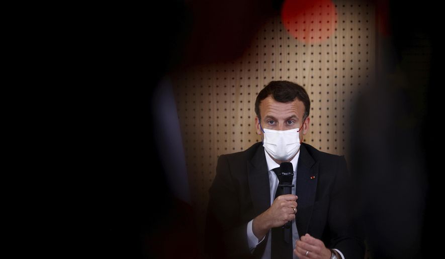 French President Emmanuel Macron, wearing a protective face mask, talks during a meeting with medical staff members during a visit in a child psychiatry department at Reims hospital, eastern France, to discuss the psychological impact of the COVID-19 crisis and the lockdown on children and teenagers in France, Wednesday, April 14, 2021. (Christian Hartmann/Pool via AP)