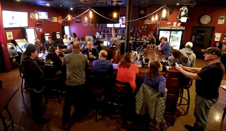 FILE - In this May 13, 2020 file photo, the Dairyland Brew Pub opens to patrons in Appleton, Wis. The Wisconsin Supreme Court on Wednesday, April 14, 2021, ruled that Gov. Tony Evers' administration does not have the authority to issue capacity limits on bars, restaurants and other businesses without approval of the Legislature, a ruling that comes two weeks after the conservative-controlled court struck down the state's mask mandate. (William Glasheen/The Post-Crescent via AP, File)