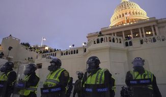 In this Wednesday, Jan. 6, 2021, photo, police form a line to guard the Capitol after violent rioters stormed the Capitol, in Washington. The top watchdog for the U.S. Capitol Police will testify to Congress for the first time about the department’s broad failures before and during the Jan. 6 insurrection. Among them was missed intelligence and old weapons that officers didn’t feel comfortable using. (AP Photo/John Minchillo)