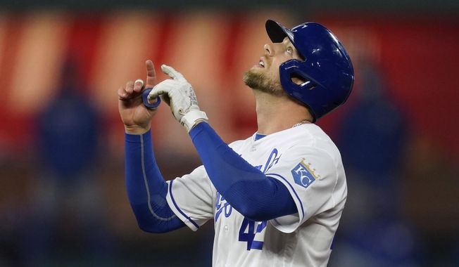Kansas City Royals&#x27; Hunter Dozier celebrates at second base after hitting an RBI-double during the fourth inning of a baseball game against the Toronto Blue Jays, Thursday, April 15, 2021, in Kansas City, Mo. (AP Photo/Charlie Riedel)