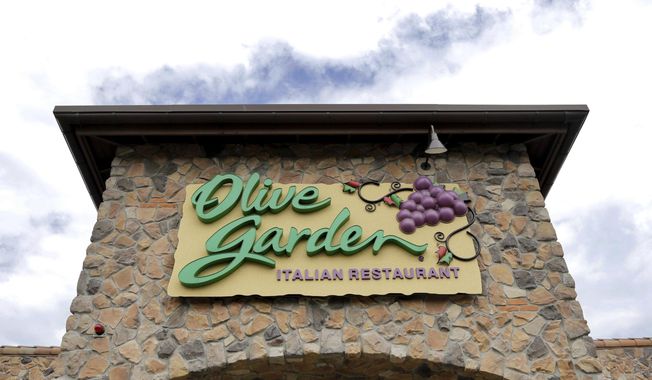 FILE - This Monday, June 27, 2016 file photo shows an Olive Garden restaurant in Methuen, Mass.  A group that seeks higher guaranteed wages for restaurant workers is suing Olive Garden’s parent company. One Fair Wage filed the lawsuit Thursday, April 15, 2021 against Orlando, Florida-based Darden Restaurants. The lawsuit says Darden pays its tipped workers subminimum wages as low as $2.13 per hour in the 43 states that allow that practice. (AP Photo/Elise Amendola)