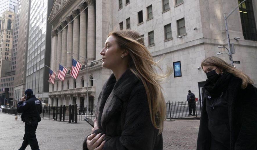FILE - In this Jan. 13, 2021 file photo, people walk by the New York Stock Exchange. Stocks are opening higher on Wall Street as traders welcome some strong reports on the economy including a drop in jobless claims and a big increase in retail spending, as well as more robust earnings from big companies including Citigroup and United Healthcare (AP Photo/Mark Lennihan, File)