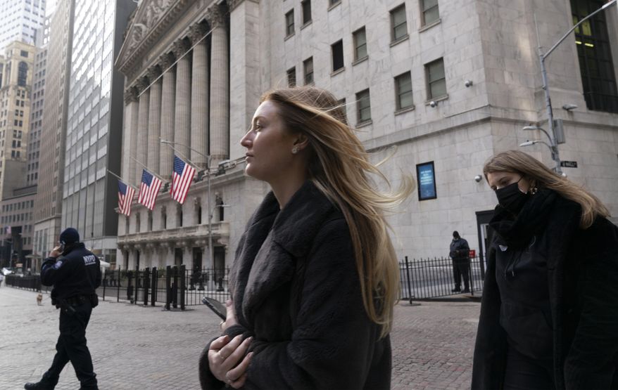 FILE - In this Jan. 13, 2021 file photo, people walk by the New York Stock Exchange. Stocks are opening higher on Wall Street as traders welcome some strong reports on the economy including a drop in jobless claims and a big increase in retail spending, as well as more robust earnings from big companies including Citigroup and United Healthcare (AP Photo/Mark Lennihan, File)