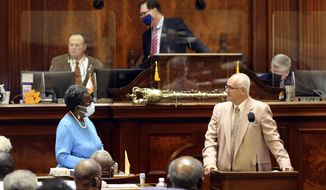 State Rep. Gilda Cobb-Hunter, D-Orangeburg, left, listens as Rep. Garry Smith, R-Simpsonville, right, talks about a bill that would require a semester course on America&#39;s founding for college students on Thursday, April 15, 2021, in Columbia, S.C. The bill passed 91-12. (AP Photo/Jeffrey Collins)