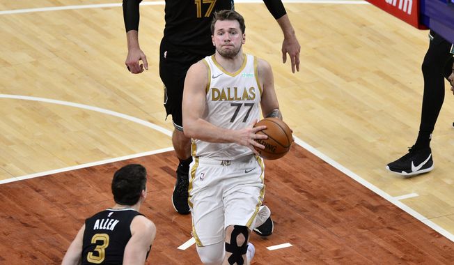 Dallas Mavericks guard Luka Doncic (77) drives to the basket in the second half of an NBA basketball game against the Memphis Grizzlies Wednesday, April 14, 2021, in Memphis, Tenn. (AP Photo/Brandon Dill)