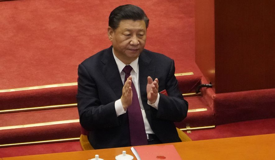 In this file photo dated Thursday, March 11, 2021, Chinese President Xi Jinping applauds during the closing session of the National People&#x27;s Congress in Beijing. (AP Photo/Sam McNeil, File)