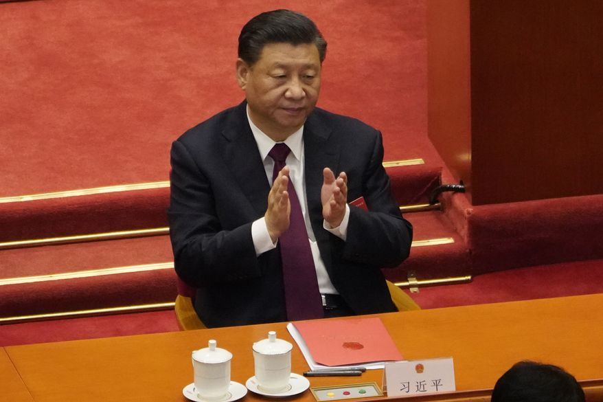 In this file photo dated Thursday, March 11, 2021, Chinese President Xi Jinping applauds during the closing session of the National People&#39;s Congress in Beijing. (AP Photo/Sam McNeil, File)