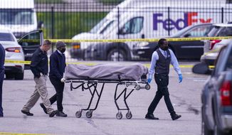 A body is taken from the scene where multiple people were shot at a FedEx Ground facility in Indianapolis, Friday, April 16, 2021. A gunman killed eight people and wounded several others before apparently taking his own life in a late-night attack at a FedEx facility near the Indianapolis airport, police said, in the latest in a spate of mass shootings in the United States after a relative lull during the pandemic. (AP Photo/Michael Conroy)
