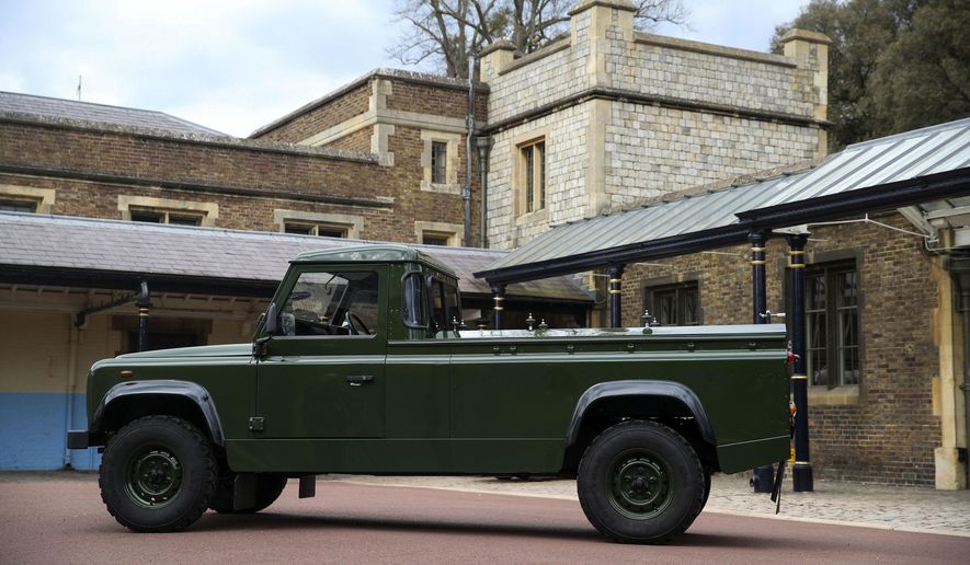 The Jaguar Land Rover that will be used to transport the coffin of the Duke of Edinburgh at his funeral on Saturday, is pictured at Windsor Castle, in Berkshire, England, Wednesday, April 14, 2021. The modified Land Rover Defender TD5 130 chassis cab vehicle was made at Land Rover&#39;s factory in Solihull in 2003 and Philip oversaw the modifications throughout the intervening years, requesting a repaint in military green and designing the open top rear and special &amp;quot;stops&amp;quot; to secure his coffin in place. (Steve Parsons/Pool Photo via AP)