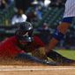 Atlanta Braves Dansby Swanson is tagged at third base by Chicago Cubs third baseman Kris Bryant during the fifth inning of a baseball game against the Friday, April 16, 2021, in Chicago. (AP Photo/Matt Marton)