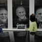 People look at images of Prince Philip displayed in the front window of &amp;quot;the Gallery at Ice&amp;quot; in Windsor, England, Wednesday, April 14, 2021. Britain&#39;s Prince Philip, husband of Queen Elizabeth II, died Friday April 9 aged 99. His funeral service will take place on Saturday at Windsor Castle. (AP Photo/Matt Dunham)