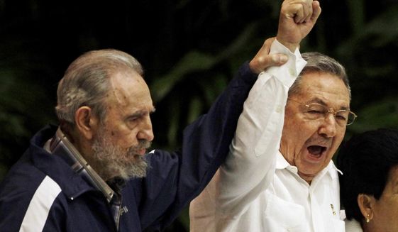 FILE - In this April 19, 2011 file photo, Fidel Castro, left, raises the hand of his brother President Raul Castro as they sing the international socialism anthem during the 6th Communist Party Congress in Havana, Cuba. For most of his life, Raul Castro played second-string to his brother, but for the past decade, it’s Raul who&#39;s been the face of communist Cuba. On Friday, April 16, 2021, Raul Castro formally announced he&#39;d step down as head of the Communist Party, leaving Cuba without a Castro in an official position of command for the first time in more than six decades. (AP Photo/Javier Galeano, File)