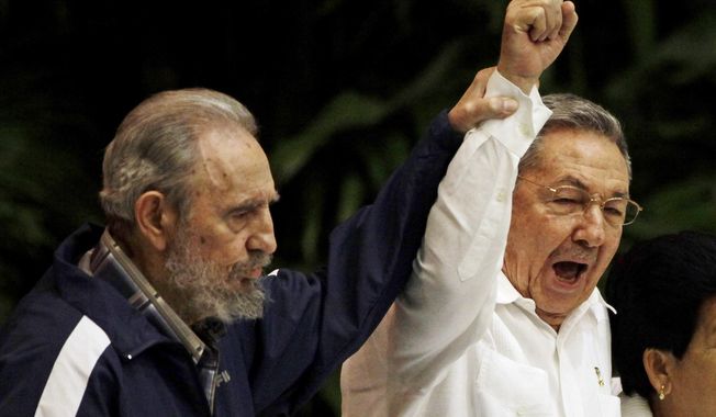 FILE - In this April 19, 2011 file photo, Fidel Castro, left, raises the hand of his brother President Raul Castro as they sing the international socialism anthem during the 6th Communist Party Congress in Havana, Cuba. For most of his life, Raul Castro played second-string to his brother, but for the past decade, it’s Raul who&#x27;s been the face of communist Cuba. On Friday, April 16, 2021, Raul Castro formally announced he&#x27;d step down as head of the Communist Party, leaving Cuba without a Castro in an official position of command for the first time in more than six decades. (AP Photo/Javier Galeano, File)