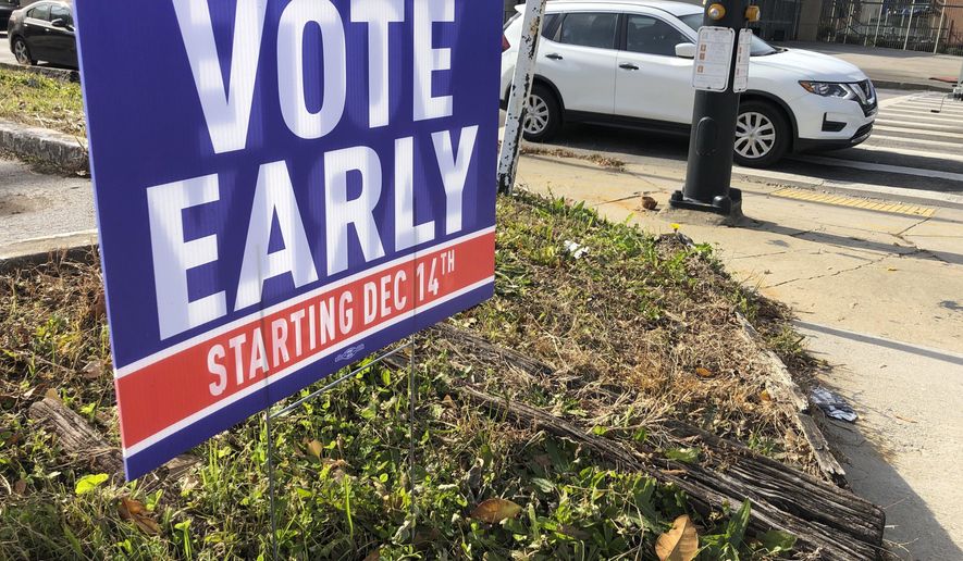 In this Dec. 11, 2020 file photo, a sign in an Atlanta neighborhood  urges people to vote early in Georgia&#39;s two U.S. Senate races.   Republicans are moving to make it harder for that to happen again, potentially affecting the voting preferences for millions of Americans in future elections. The GOP&#39;s campaign to place new restrictions on mail-in and early voting in certain states will force voters to contend with new rules on what are popular and proven methods of casting ballots. (AP Photo/Jeff Amy, File)