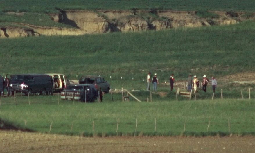 FILE - In this June 13, 1996, file photo, members of the Freemen group surrender to FBI agents at the negotiation site on the Freeman compound outside Jordan, Mont. A member of the anti-government Montana Freemen who took part in the extremist group's 81-day armed standoff with FBI agents has died in prison. Federal officials say Russell Dean Landers, 69, died Saturday, April 10, 2021, while in custody at the Federal Correctional Institution at Terre Haute, Ind. (AP Photo/Michael S. Green, File)