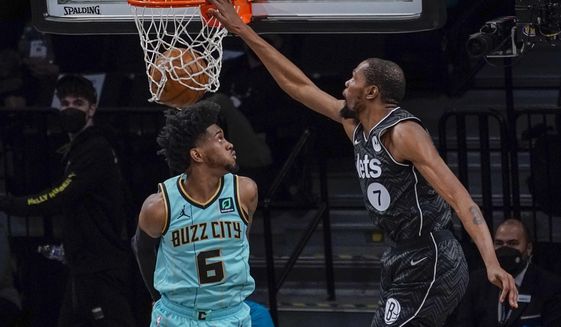 Brooklyn Nets forward Kevin Durant (7) goes to the basket past Charlotte Hornets forward Jalen McDaniels (6) during the second half of an NBA basketball game Friday, April 16, 2021, in New York. (AP Photo/Mary Altaffer)
