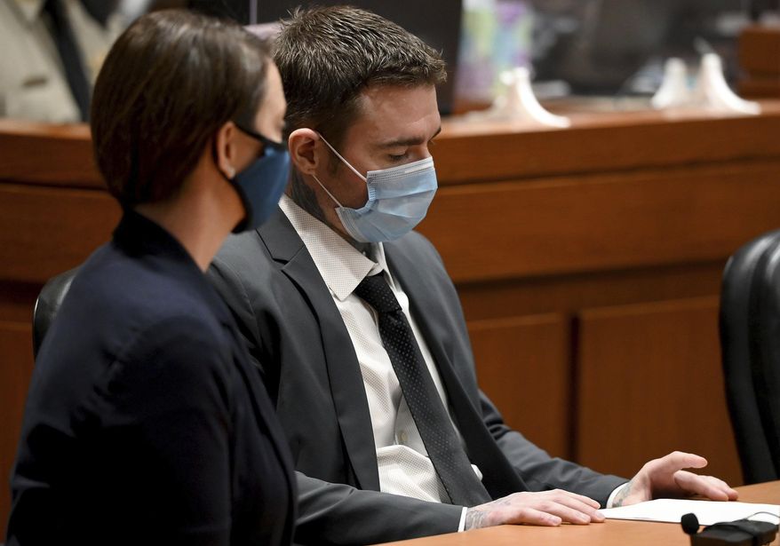 Kylr Yust, right, and attorney Molly Hastings sits at the defense table after the judge informed Yust of the jury's sentencing recommendations Friday, April 16, 2021, at the Cass County Justice Center in Harrisonville, Missouri. The jury in the murder trial recommended a sentence of 15 years for voluntary manslaughter of Kara Kopetsky and a life sentence (30 years) for the second-degree murder of Jessica Runions Friday, April 16, 2021. Sentencing is set for June 7. (Jill Toyoshiba/The Kansas City Star via AP)
