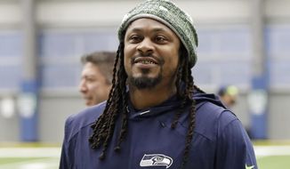 FILE - Seattle Seahawks running back Marshawn Lynch walks off the field after NFL football practice in Renton, Wash., in this Friday, Dec. 27, 2019, file photo. During Marshawn Lynch’s 12 NFL seasons he earned a reputation for his fearless style on the field, while remaining one of the league’s most reclusive figures off the field. Now the retired running back is lending his voice to try to help members of Black and Hispanic communities make more informed decisions about receiving COVID-19 vaccines. Lynch released a 30-minute interview with Dr. Anthony Fauci on his YouTube channel Friday, April 16, 2021, becoming the latest prominent athlete to sit down with him to discuss the efficacy of COVID-19 vaccines as the U.S. continues to combat the pandemic.  (AP Photo/Ted S. Warren, File)