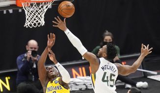Utah Jazz guard Donovan Mitchell (45) defends against Indiana Pacers guard Aaron Holiday (3) in the first half of an NBA basketball game Friday, April 16, 2021, in Salt Lake City. (AP Photo/Rick Bowmer)