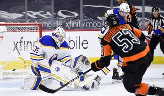 Buffalo Sabres&#39; goaltender Linus Ullmark, left, is unable to make a save on a goal by Philadelphia Flyers&#39; Shayne Gostisbehere (53) during the third period of an NHL hockey game, Sunday, April 11, 2021, in Philadelphia. (AP Photo/Derik Hamilton)