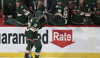 Minnesota Wild&#39;s Nick Bonino (13) high fives teammates on the bench in celebration after scoring a goal against the San Jose Sharks, during the first period of an NHL hockey game Friday, April 16, 2021, in St. Paul, Minn. (AP Photo/Stacy Bengs)