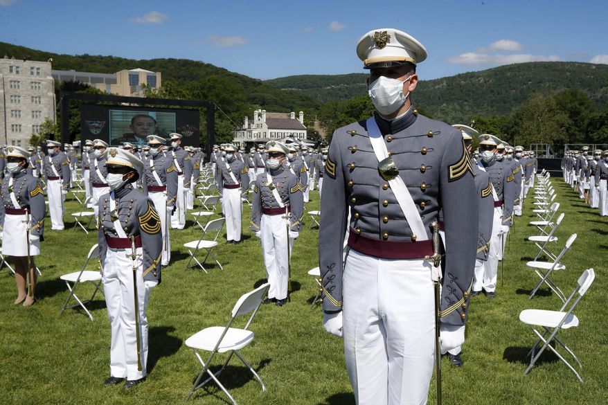 In this June 13, 2020, file photo, United States Military Academy graduating cadets wear face masks as they stand next to their socially distanced seats during commencement ceremonies in West Point, N.Y. (AP Photo/John Minchillo, Pool) **FILE**