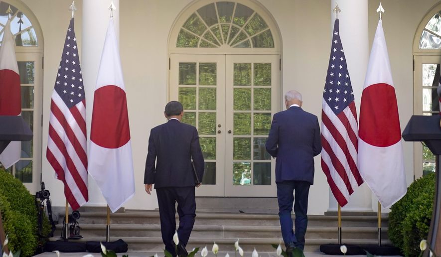 President Joe Biden and Japanese Prime Minister Yoshihide Suga leave after a news conference in the Rose Garden of the White House, Friday, April 16, 2021, in Washington. (AP Photo/Andrew Harnik)