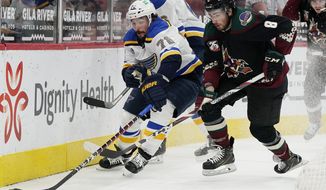 St. Louis Blues defenseman Justin Faulk (72) works against Arizona Coyotes center Nick Schmaltz (8) for the puck during the first period of an NHL hockey game Saturday, April 17, 2021, in Glendale, Ariz. (AP Photo/Ross D. Franklin)