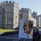Artist Kaya Mar holds a portrait of Prince Philip ahead of the Prince&#39;s funeral in Windsor, England Saturday April 17, 2021. Philip died April 9 at the age of 99 after 73 years of marriage to Britain&#39;s Queen Elizabeth II. Coronavirus restrictions mean there will be only 30 mourners for the service, including the widowed queen, her four children and her eight grandchildren. (AP Photo/Frank Augstein)