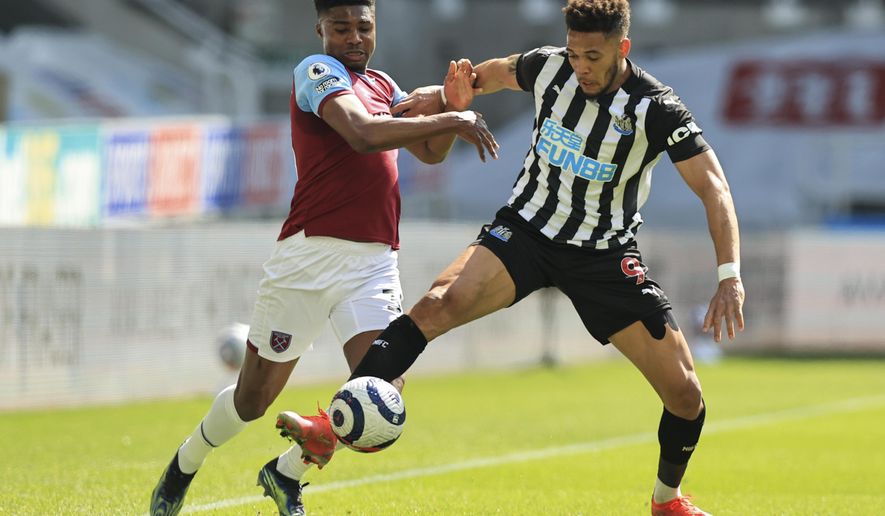 Newcastle&#39;s Joelinton, right, battles for the ball with West Ham&#39;s Ben Johnson during the English Premier League soccer match between Newcastle United and West Ham United at St James&#39; Park, Newcastle, England, Saturday April 17, 2021. (AP Photo/Dave Rogers/Pool)