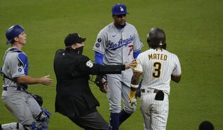 Los Angeles Dodgers starting pitcher Dennis Santana, center, has words with San Diego Padres&#39; Jorge Mateo (3) after Mateo was hit by a pitch during the tenth inning of a baseball game Friday, April 16, 2021, in San Diego. (AP Photo/Gregory Bull)