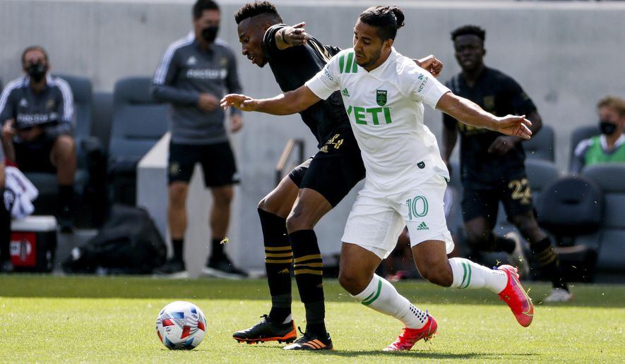 Austin FC midfielder Cecilio Dominguez (10) and Los Angeles FC midfielder Mark-Anthony Kaye vie for the ball during the first half of an MLS soccer match Saturday, April 17, 2021, in Los Angeles. (AP Photo/Ringo H.W. Chiu)