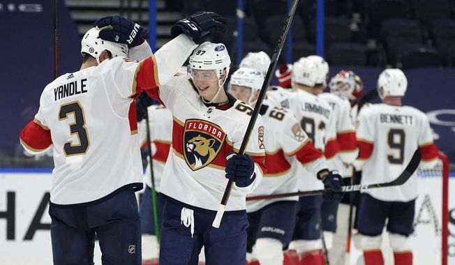 Florida Panthers defenseman Keith Yandle (3) and right wing Nikita Gusev (97)ref52 celebrate after the team defeated the Tampa Bay Lightning during an NHL hockey game Saturday, April 17, 2021, in Tampa, Fla. (AP Photo/Chris O&#x27;Meara)