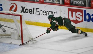 Minnesota Wild center Nico Sturm makes a wraparound shot for goal against the San Jose Sharks during the second period of an NHL hockey game Saturday, April 17, 2021, in St. Paul, Minn. (AP Photo/Craig Lassig)